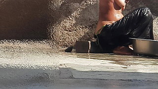 Indian sister-in-law is bathing in the open courtyard of the house, putting a finger in her burrow and rubbing the body, sister-in-law is washing the bathroom.