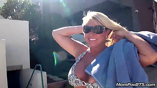 Busty blonde MILF flaunts her assets on a public beach