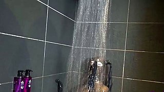 Busty MILF vixen in latex plays with herself in the shower