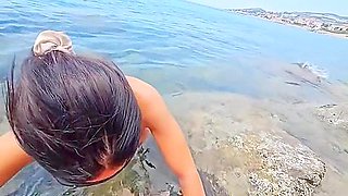 A Fisher, Positioned On The Rocky Shore, Is Offering Me His Catch
