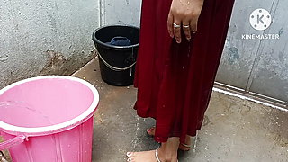 Indian housewife bathing with