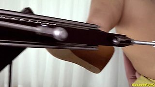 A mature, full-figured woman boasting extremely large breasts is intensely penetrated by a mechanical device.