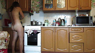 Naked hostess in the kitchen
