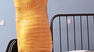 A Cute Barefoot Girlfriend Uses Tape to Bind Her Whole Body, Playing with Her Cute Bare Feet