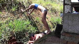 Nude babe stomping her slave in the backyard