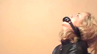 Mandy Taylor frogtied in a leather straitjacket